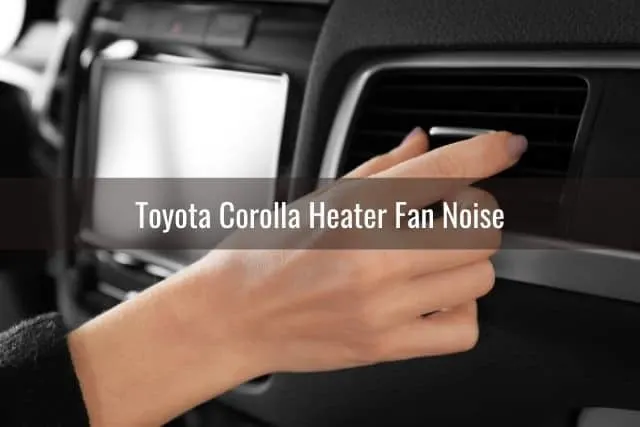 Hand adjusting the position of a car heater vent