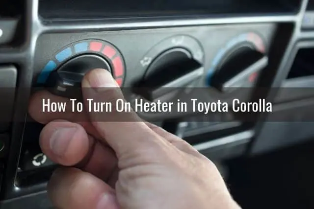 Hand adjusting the car temperature control knob