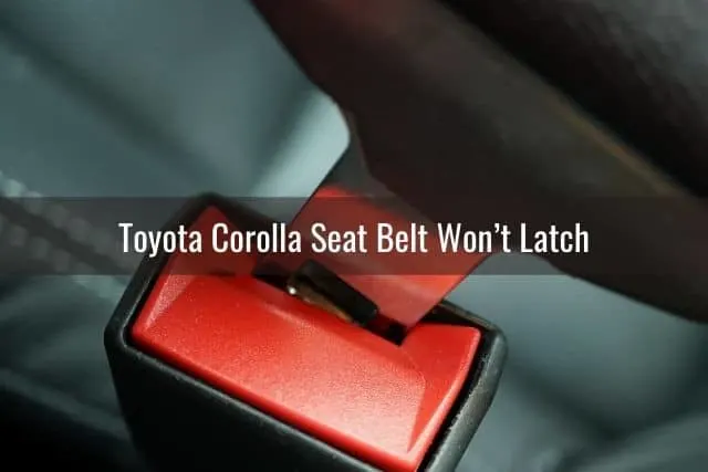 Car seat belt latch about to snap into buckle