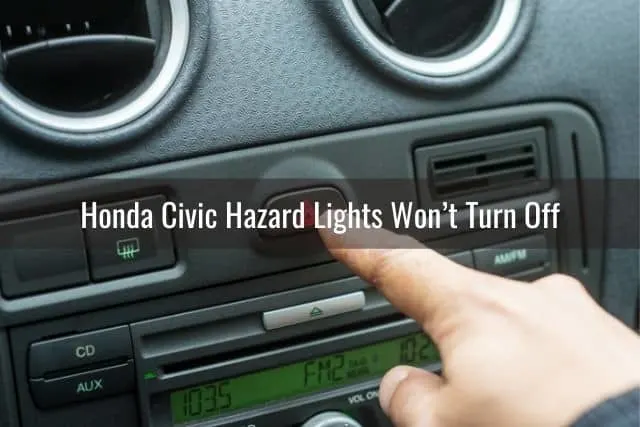 Finger pushing hazard light button in car