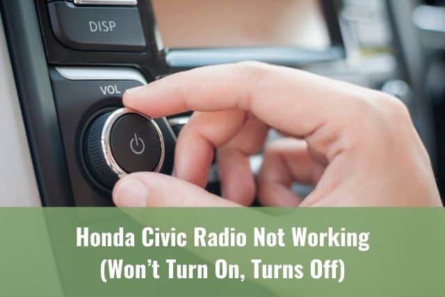 Hand adjusting car radio power knob