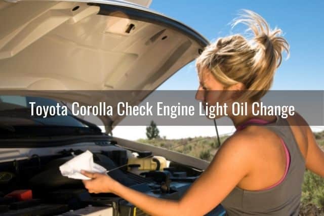 Female checking engine oil dipstick