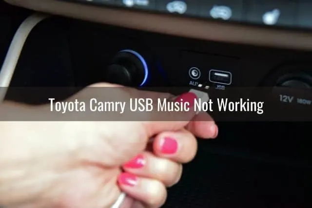 Female hand connecting USB cable into car