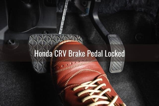 Leather shoe pressed down on car brake pedal