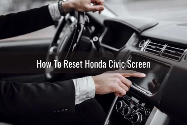 Hand pushing button on car touchscreen