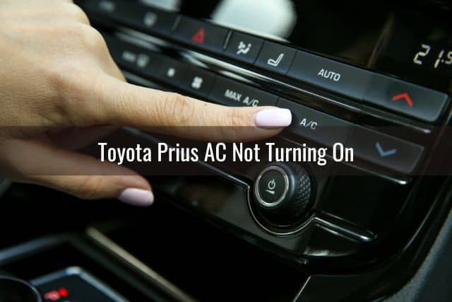 Female finger pressing car AC button