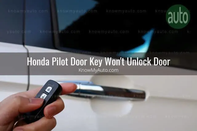 Hand holding key fob opening car door