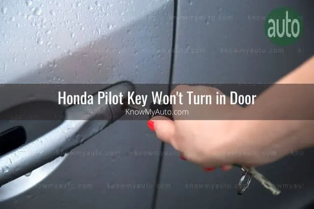 Female hand using key to unlock car door