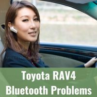Female driving while wearing bluetooth earpiece