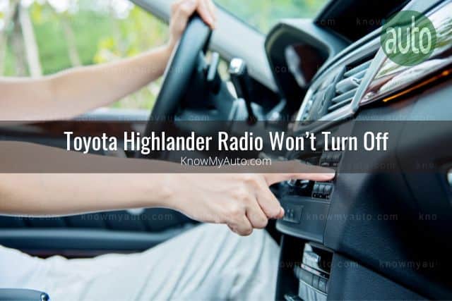 Car driver pushing radio controls