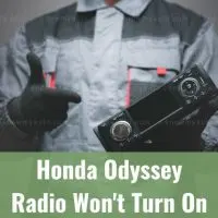 Car mechanic holding radio unit