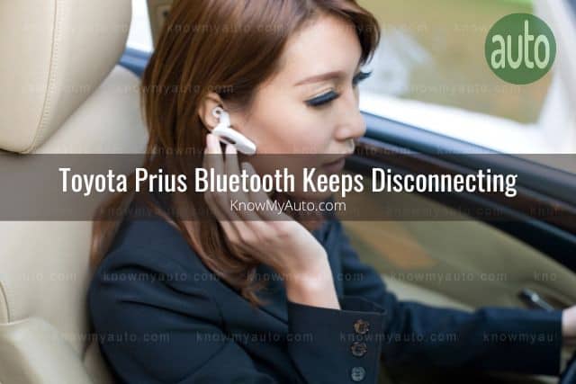 Woman talking through her Bluetooth ear piece in car