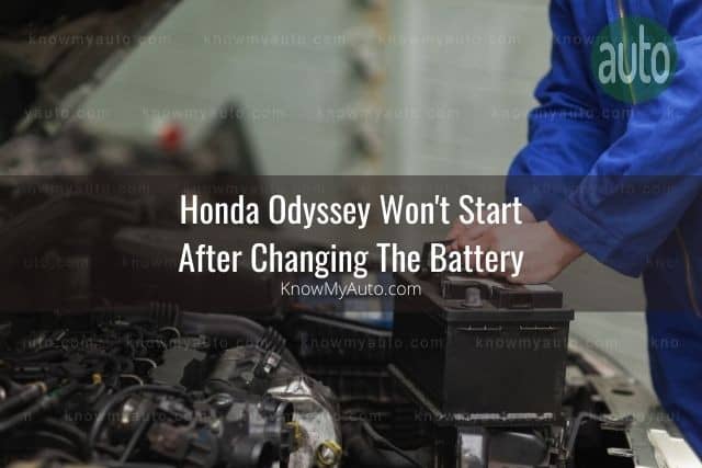 Car mechanic changing battery