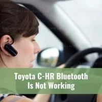Female car driver talking using Bluetooth headset