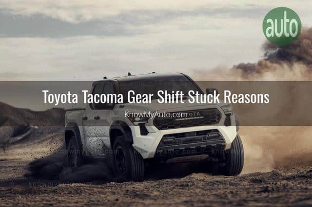 White Toyota Tacoma driving on dirt road